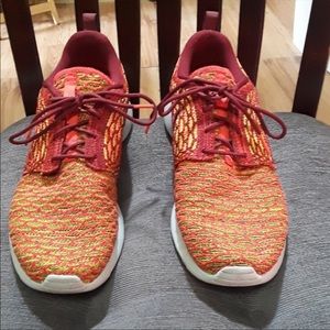 Burgundy and gold Nike Roshes